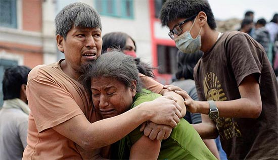 Warga saling membantu usai gempa Nepal di kawasan Alun-alun Durbar,  25 April 2015. Kawasan ini merupakan situs warisan dunia dari UNESCO di Kathmandu, Nepal FOTO : AFP/PRAKASH MATHEMA