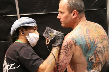 Seorang seniman tato tengah berkreasi dalam ajang Pameran Tato dan Seni Tubuh Australia di Perth. (Foto: dokumentasi penulis) 
